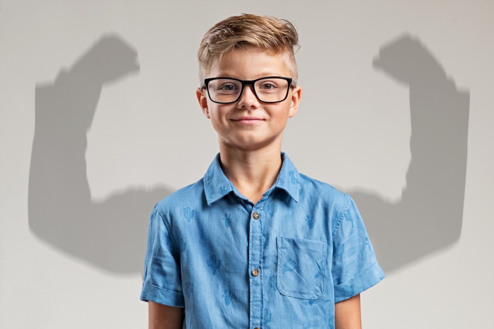 Child in front of big arms shadow- confident child