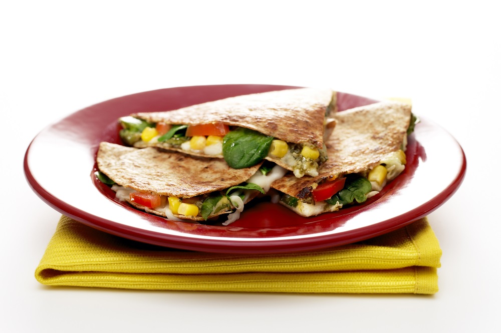 Closeup of quesadilla on plate on white background