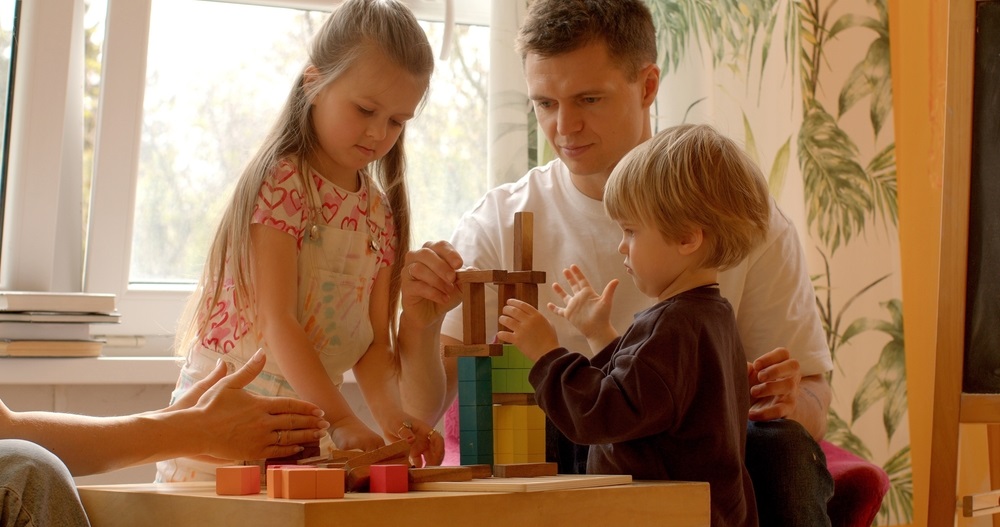 Social Skills: Playing with building blocks in a family setting provides children with opportunities to practice social skills 